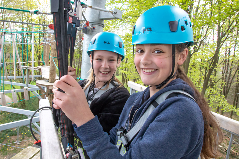 Two girls enjoying the high ropes