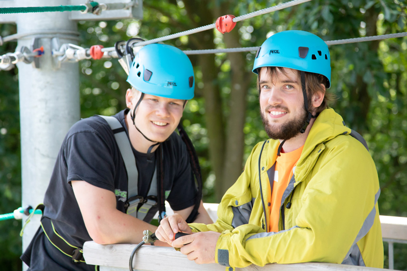 Two men enjoying the high ropes adventure