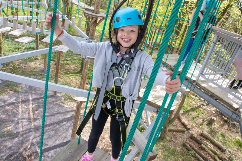 A photo of a girl enjoying the high ropes